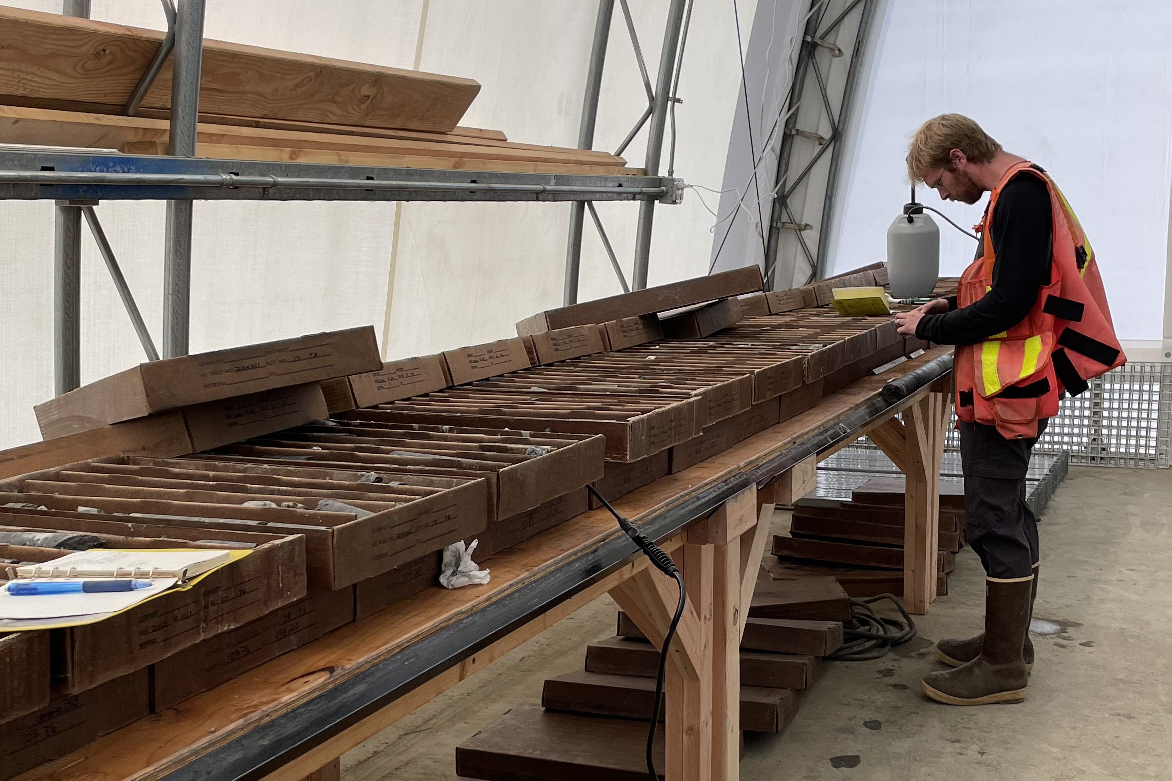 USGS geologist recording data on graphite mineralization in core sample